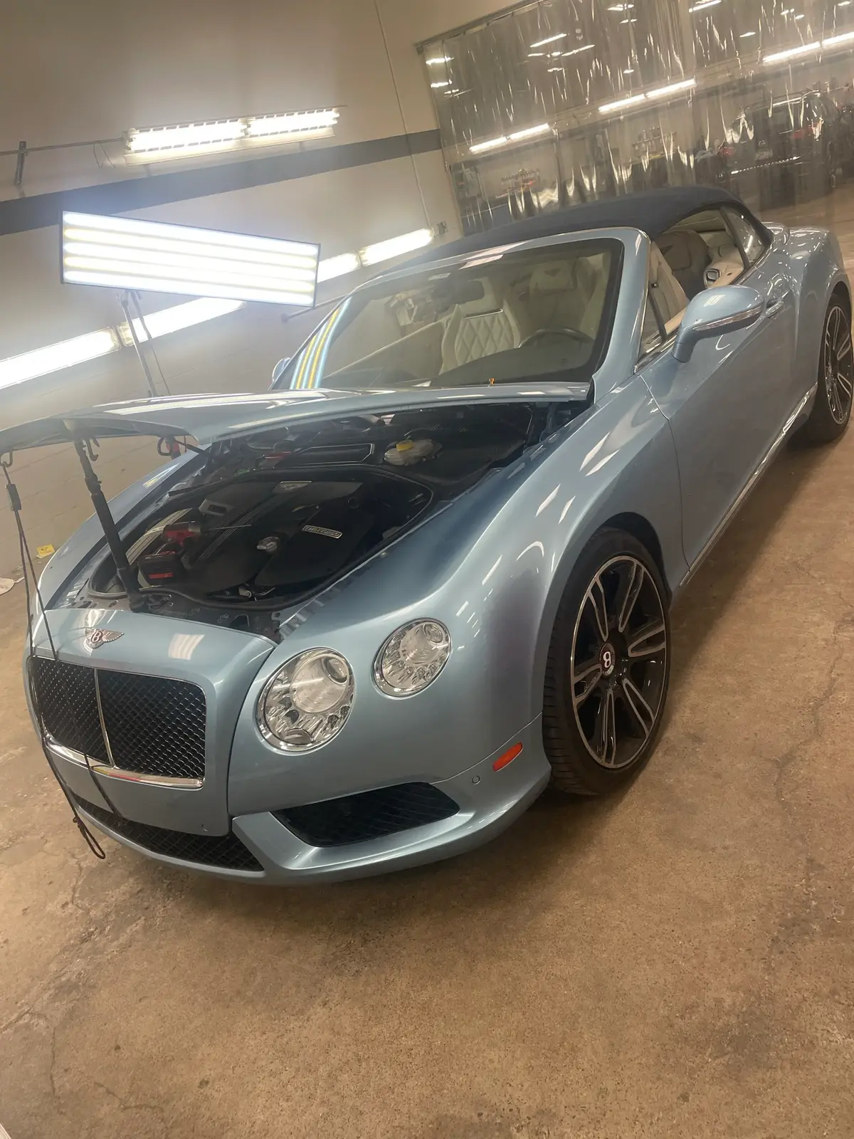 Bentley Continental inside Hail Solutions paintless dent repair shop in Olathe, Kansas