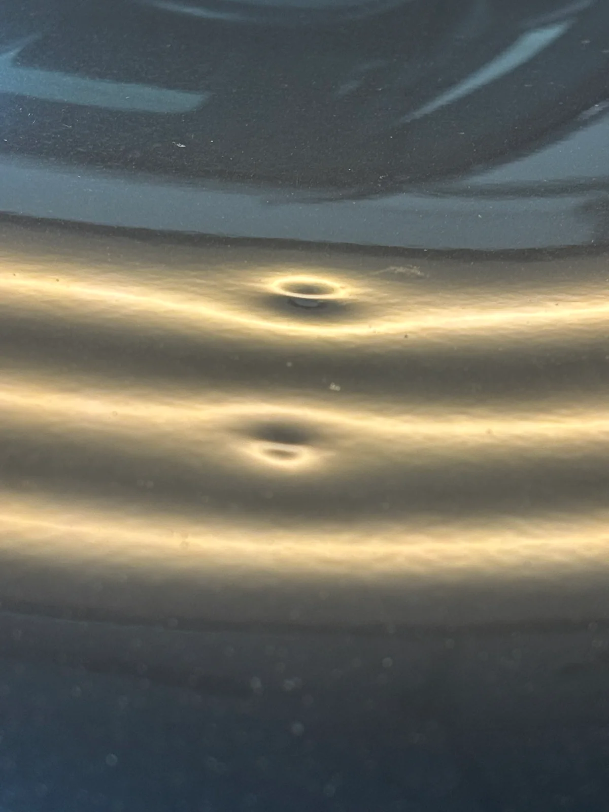 Hail-damaged vehicle hood under LED line-board inspection at Hail Solutions — comprehensive damage mapping for an Independence, MO customer